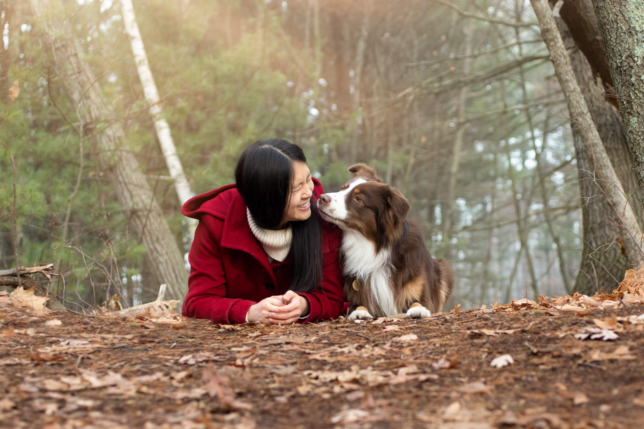 Woman in Reading woods getting a kiss from her dog